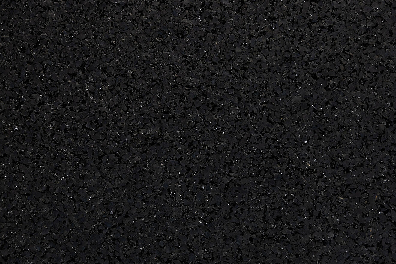 Close-up of REGUPOL resist fire's granulate structure – recycled rubber granules with flame-retardant properties.